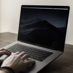 Hands on a laptop typing.
