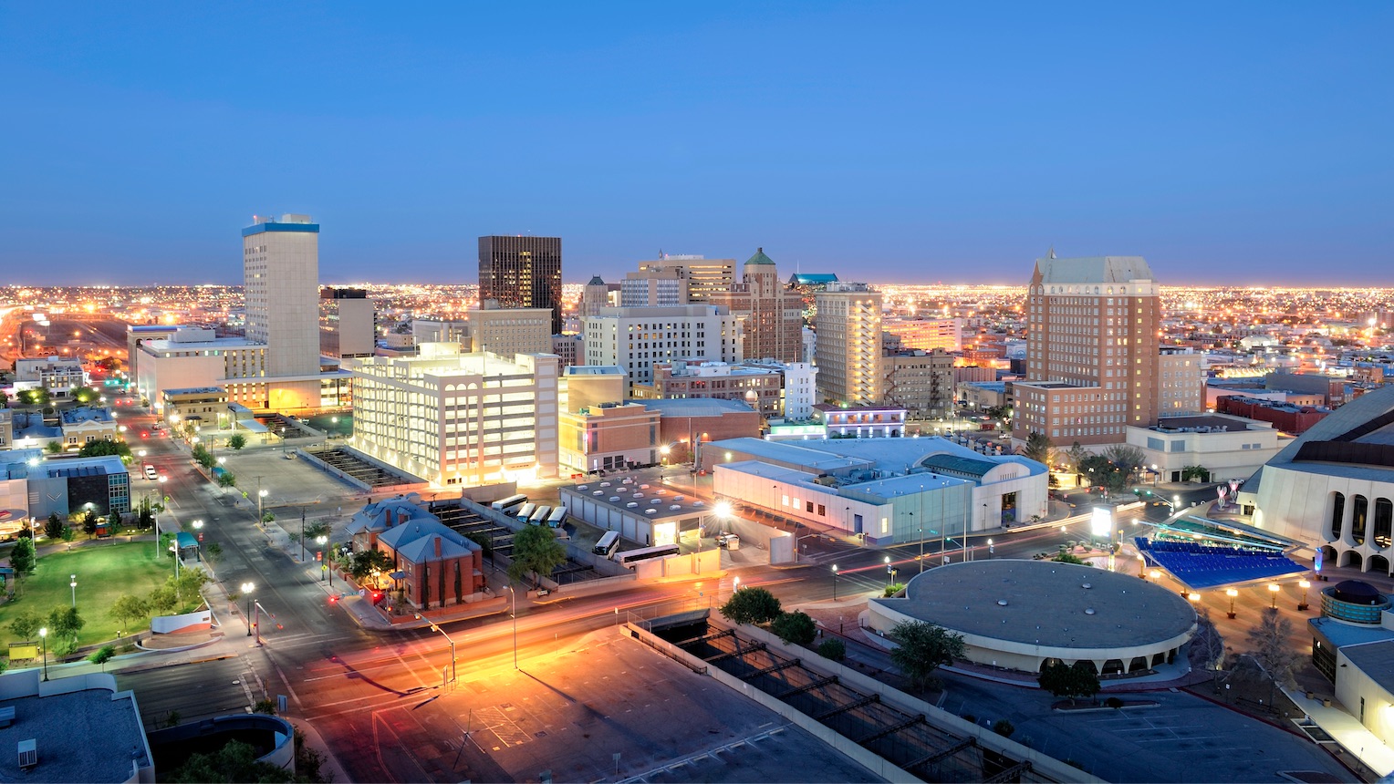 Night image of downtown El Paso, Texas. Showing the Civic Center, the El Nube Museum, the Plaza Hotel, and the Chase Building.
