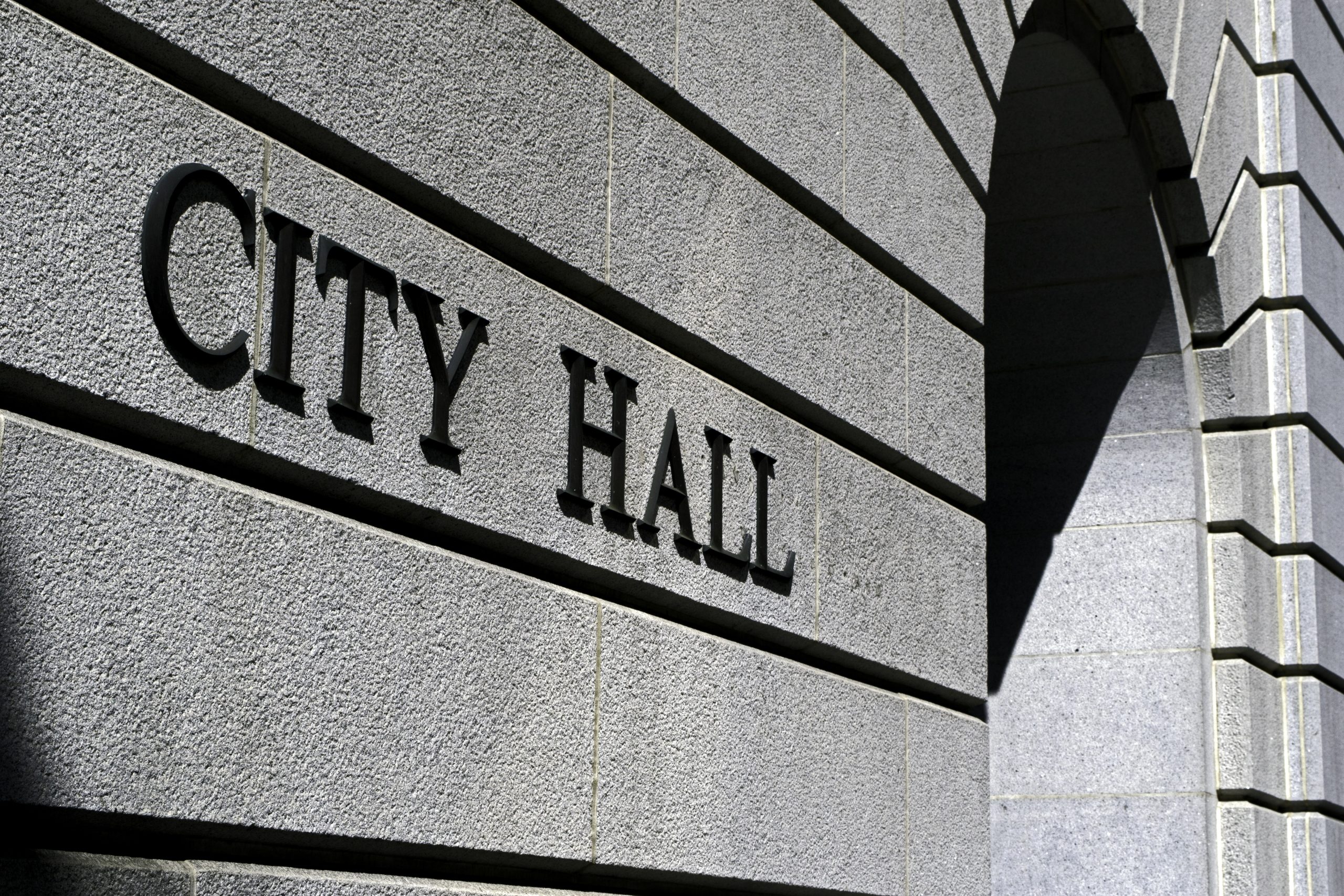 Building with the words' City Hall' on it. The image is black and grey scale.